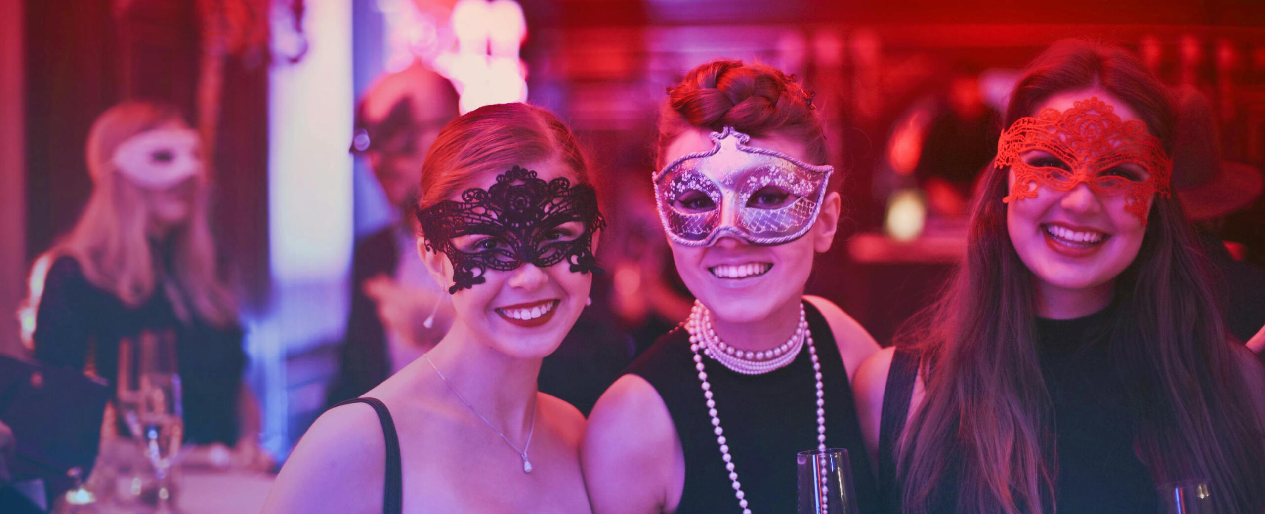 Halloween Partygoers Three women in masquerade at a Halloween party